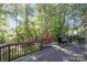 Expansive back deck with railings, outdoor furniture and wooded views of the backyard at 9022 Taunton Dr, Huntersville, NC 28078