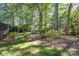 The backyard features lush greenery and mature trees, creating a private oasis at 9022 Taunton Dr, Huntersville, NC 28078