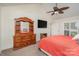 Comfortable primary bedroom with a ceiling fan, a dresser with mirror, and an ensuite bath at 9022 Taunton Dr, Huntersville, NC 28078