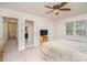 Bedroom featuring neutral color walls, a ceiling fan, and a large window allowing for natural light at 9022 Taunton Dr, Huntersville, NC 28078