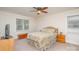 Bedroom with a ceiling fan, a window with blinds, and queen bed with floral pattern bedding at 9022 Taunton Dr, Huntersville, NC 28078