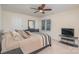 Bedroom with neutral walls, a ceiling fan, a window with blinds, and a queen size bed at 9022 Taunton Dr, Huntersville, NC 28078