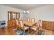 Traditional dining room with hardwood floors, classic chandelier, and a built-in china cabinet for elegant storage at 9022 Taunton Dr, Huntersville, NC 28078