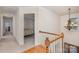 Upstairs hallway with hardwood floors, a view of the foyer below, and bedrooms just off the hall at 9022 Taunton Dr, Huntersville, NC 28078