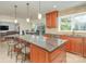 Bright kitchen with a granite island, barstool seating, custom cabinets, and stainless steel appliances at 9022 Taunton Dr, Huntersville, NC 28078