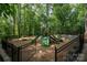 Community playground featuring slides and climbing equipment, all surrounded by lush trees at 9022 Taunton Dr, Huntersville, NC 28078