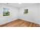 Bedroom with hardwood flooring and two windows with natural light at 908 Coventry Rd, Kannapolis, NC 28081