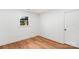 A bedroom with hardwood floors, white walls, and a window at 908 Coventry Rd, Kannapolis, NC 28081