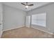 Neutral bedroom featuring carpet, ceiling fan and built-in storage at 944 Treasure Ct, Fort Mill, SC 29708