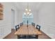 Dining room with hardwood floors, and a wooden table with black chairs under chandelier at 944 Treasure Ct, Fort Mill, SC 29708