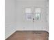 Bright foyer features hardwood floors, white wainscoting, and glass-paneled doors with a rug at 944 Treasure Ct, Fort Mill, SC 29708