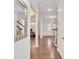 Bright foyer with gleaming hardwood floors, column, and view of the living room at 944 Treasure Ct, Fort Mill, SC 29708