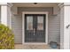 Close-up of elegant double front doors with decorative glass inserts and house number 944 at 944 Treasure Ct, Fort Mill, SC 29708