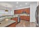 Well-equipped kitchen with stainless steel appliances, granite countertops, and rich wood cabinetry at 944 Treasure Ct, Fort Mill, SC 29708