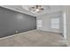 Spacious main bedroom featuring a tray ceiling, ceiling fan and neutral carpeting at 944 Treasure Ct, Fort Mill, SC 29708