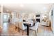 Bright dining room with hardwood floors, a modern table setting, and an open view to the living area at 9851 Quercus Ln, Huntersville, NC 28078