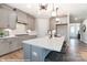 Contemporary kitchen with light gray cabinets, a center island with barstool seating, and hardwood floors at 9851 Quercus Ln, Huntersville, NC 28078