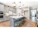 Modern kitchen with gray cabinets, a central island, and stylish pendant lighting, creating an inviting space at 9851 Quercus Ln, Huntersville, NC 28078