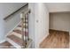 Elegant stairway with hardwood treads and a modern handrail, leading to the upper levels of the home at 9851 Quercus Ln, Huntersville, NC 28078