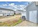 Backyard featuring a grass lawn surrounded by privacy fences and other homes at 10422 Stokeshill Ct, Pineville, NC 28134