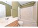 Bathroom featuring a combination tub and shower unit, a toilet and a sink at 10422 Stokeshill Ct, Pineville, NC 28134
