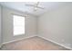Bedroom with neutral carpet, a ceiling fan and one window providing natural light at 10422 Stokeshill Ct, Pineville, NC 28134