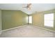 Spacious carpeted bedroom with ceiling fan and natural light from two windows at 10422 Stokeshill Ct, Pineville, NC 28134