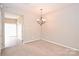 Cozy dining room with a chandelier, neutral paint and beige carpet flooring at 10422 Stokeshill Ct, Pineville, NC 28134