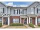 A charming townhouse with a brick and gray siding exterior and well-maintained landscaping at 10422 Stokeshill Ct, Pineville, NC 28134