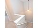 Carpeted staircase with white railing and decorative light fixture at 10422 Stokeshill Ct, Pineville, NC 28134
