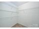 Walk-in closet with carpet and metal shelving for organized storage at 10422 Stokeshill Ct, Pineville, NC 28134