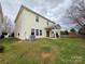 View of the home's backyard with a covered patio, lawn, and partial fence at 10927 Kinnairds St, Charlotte, NC 28278