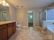 Well-lit bathroom with a vanity, toilet, and tiled floors at 10927 Kinnairds St, Charlotte, NC 28278