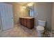 Double vanity bathroom with tiled flooring and a toilet at 10927 Kinnairds St, Charlotte, NC 28278
