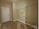 Functional laundry room with tile floor and wire rack at 10927 Kinnairds St, Charlotte, NC 28278
