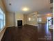 Spacious living room featuring hardwood floors, a fireplace, and an open layout at 10927 Kinnairds St, Charlotte, NC 28278