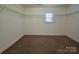 Walk-in closet with shelving and carpeted floors at 10927 Kinnairds St, Charlotte, NC 28278