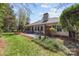 Large backyard with patio furniture, manicured lawn, and a garden area perfect for outdoor gatherings at 11542 Laurel View Dr, Charlotte, NC 28273