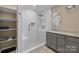 Bathroom with white tiled shower, bench seat, and a single vanity at 11542 Laurel View Dr, Charlotte, NC 28273