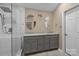 Bathroom with double vanity, updated shower with Rainfall shower head, and gray cabinets at 11542 Laurel View Dr, Charlotte, NC 28273