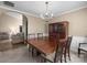 Formal dining area showcasing a large wooden table, china cabinet, and classic chandelier at 11542 Laurel View Dr, Charlotte, NC 28273