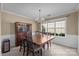 Formal dining room featuring a large window, chandelier, and classic wainscoting at 11542 Laurel View Dr, Charlotte, NC 28273