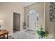 Inviting foyer with tile flooring, arched window above the door, and neutral paint at 11542 Laurel View Dr, Charlotte, NC 28273