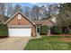 Charming brick home with manicured lawn, two-car garage, and inviting entryway at 11542 Laurel View Dr, Charlotte, NC 28273