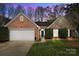 Charming brick home with manicured lawn, two-car garage, and inviting entryway at 11542 Laurel View Dr, Charlotte, NC 28273