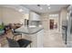 Open-concept kitchen with counter seating, tile floors, and eat-in dining area at 11542 Laurel View Dr, Charlotte, NC 28273