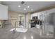 Bright kitchen features stainless steel appliances, gray countertops, and white cabinetry at 11542 Laurel View Dr, Charlotte, NC 28273