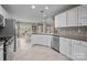 Open kitchen with stainless steel appliances, white cabinets, and lots of natural light at 11542 Laurel View Dr, Charlotte, NC 28273