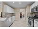 Bright kitchen featuring white cabinets, stainless steel appliances, and tile floors at 11542 Laurel View Dr, Charlotte, NC 28273