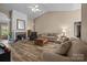 Spacious living room features a fireplace, ceiling fan, and plenty of seating at 11542 Laurel View Dr, Charlotte, NC 28273